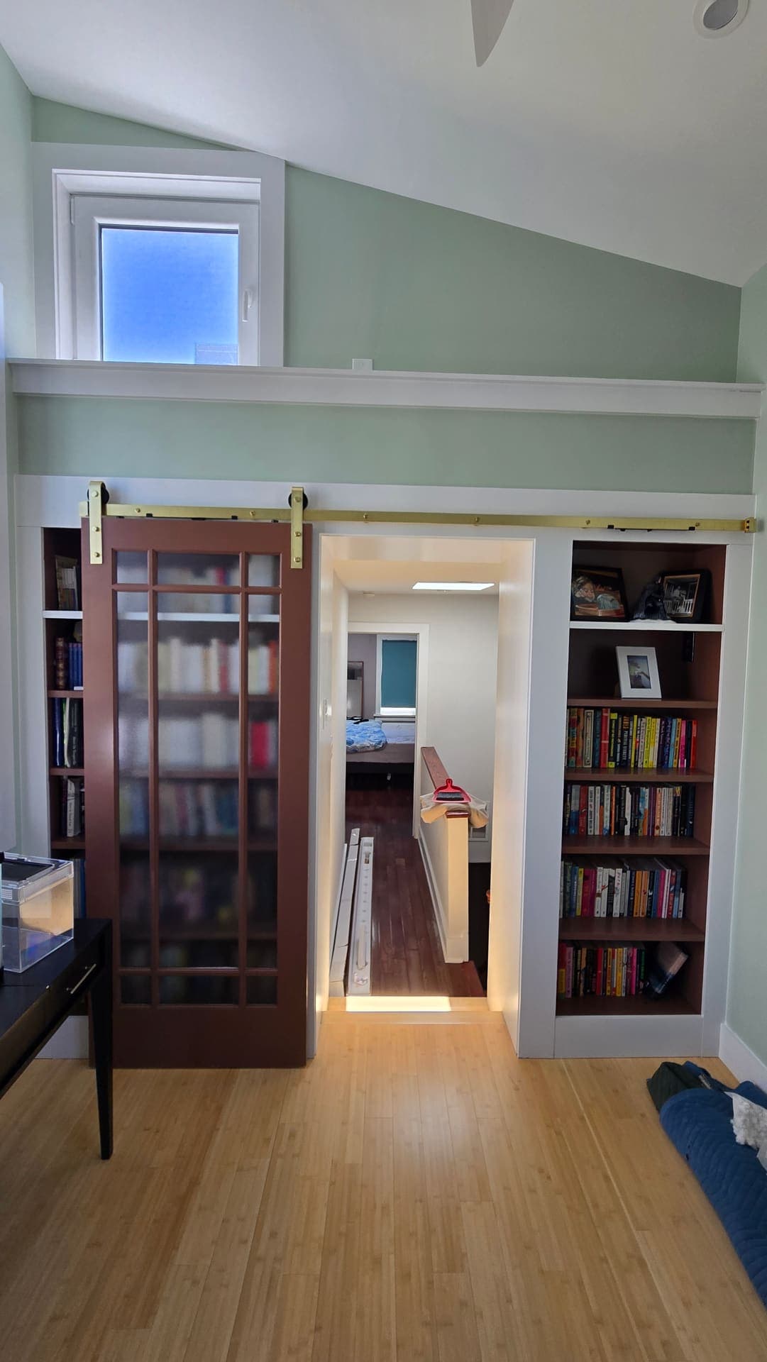 Built in bookcase wall with glazed door and bamboo floor