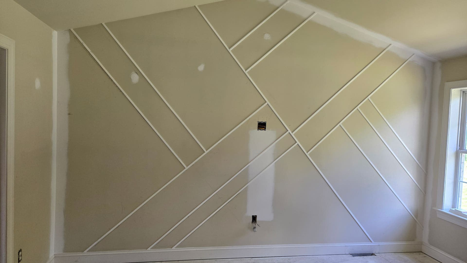 Geometric trim accent wall built and ready for paint