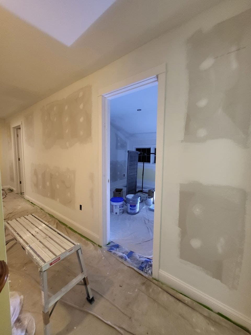 Hallway drywall patches skim coated