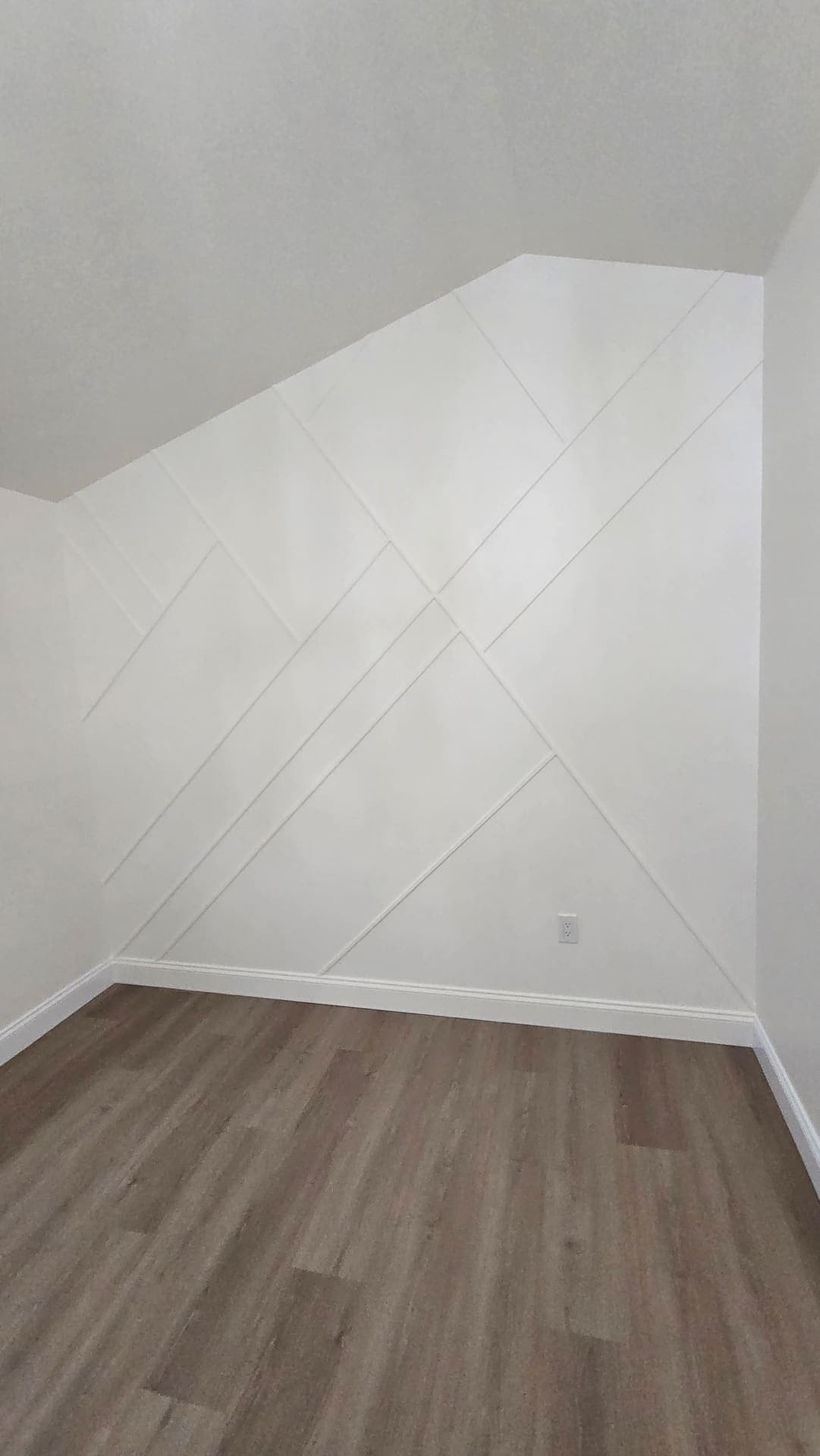 Painted geometric accent wall with new LVP flooring