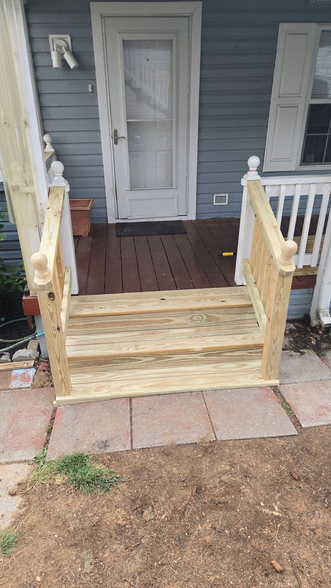 New pressure treated porch steps with railings